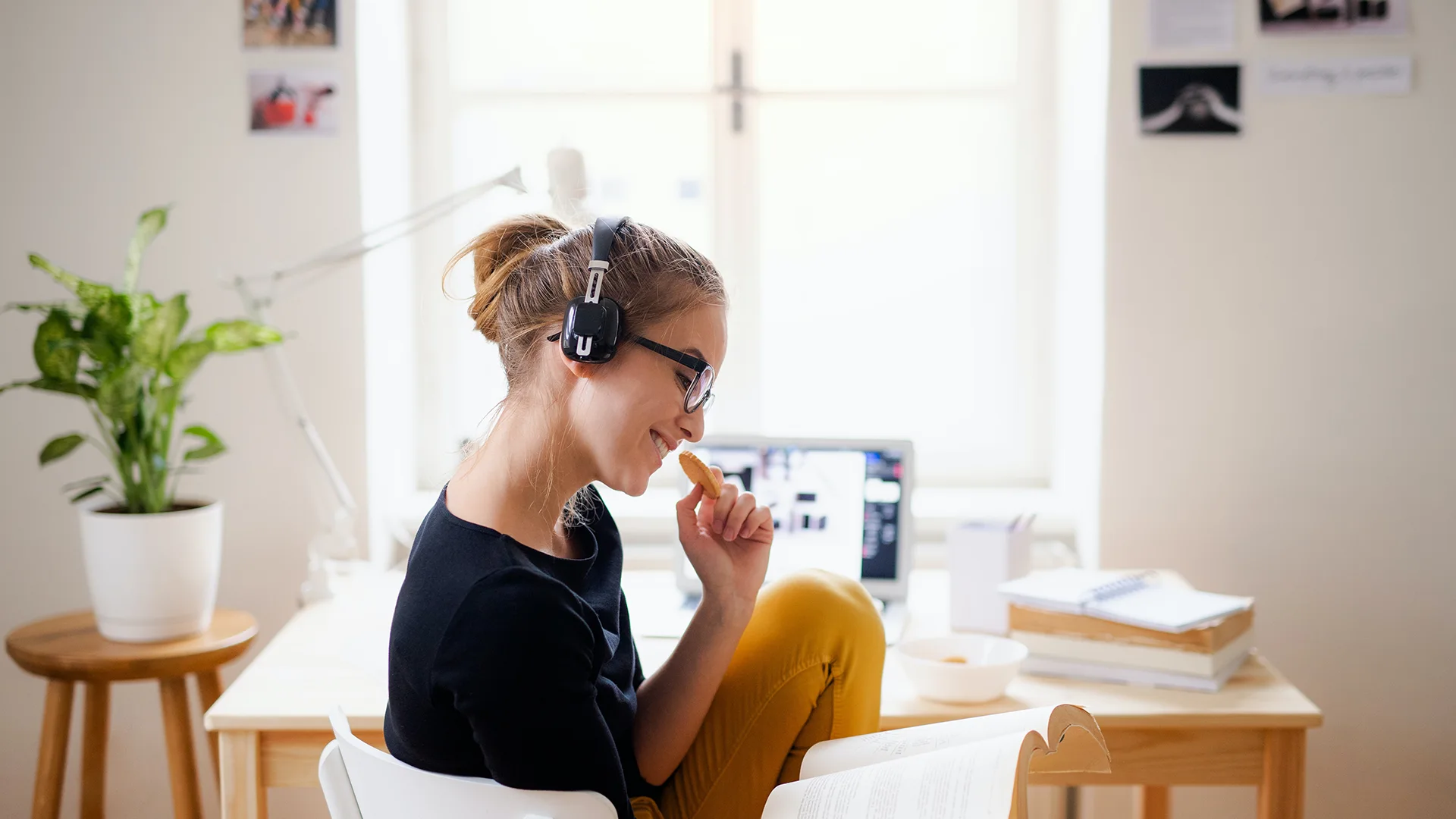 Female student is listening to motivational music while studying.